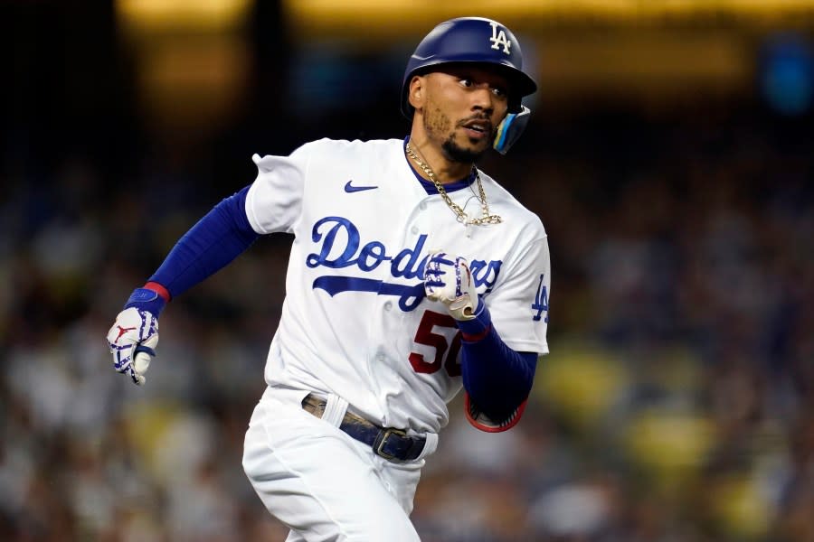 Los Angeles Dodgers’ Mookie Betts rounds first base as he doubles during the third inning of a baseball game against the Colorado Rockies Saturday, Oct. 1, 2022, in Los Angeles. (AP Photo/Marcio Jose Sanchez)