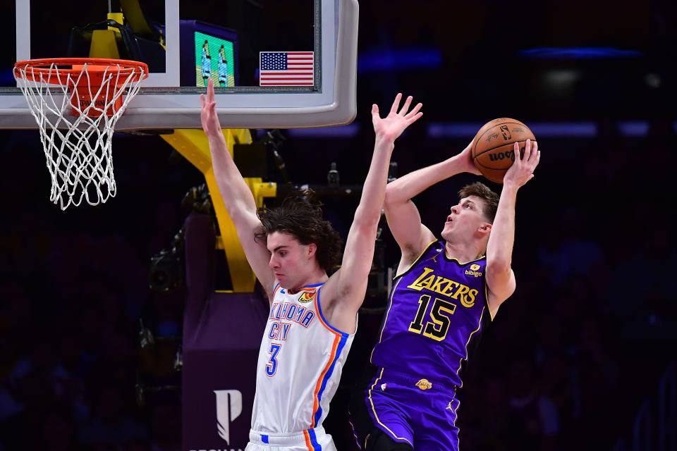 Los Angeles Lakers guard Austin Reaves (15) shoots against Oklahoma City Thunder guard Josh Giddey (3) during the first half of Friday's game at Crypto.com Arena in Los Angeles.