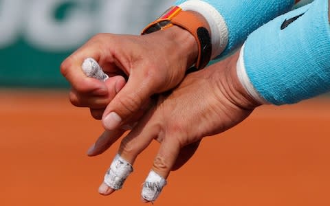 Nadal appears to struggle with cramping early on in the third set - Credit: AP