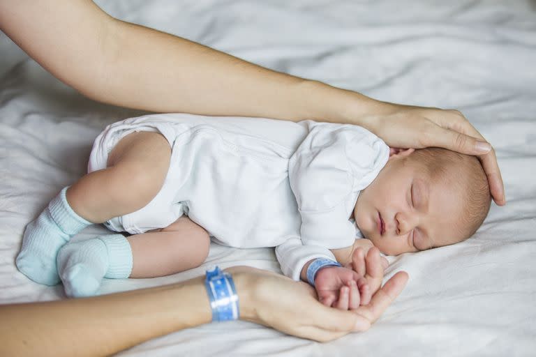 Newborn baby with his mom, first days of life