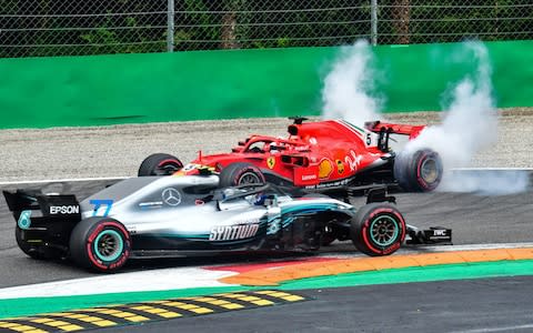 Mercedes' Finnish driver Valtteri Bottas (front) drives past Ferrari's German driver Sebastian Vettel's car after Vettel crashed with Mercedes' British driver Lewis Hamilton during the Italian Formula One Grand Prix at the Autodromo Nazionale circuit in Monza on September 2, 2018 - Credit: AFP