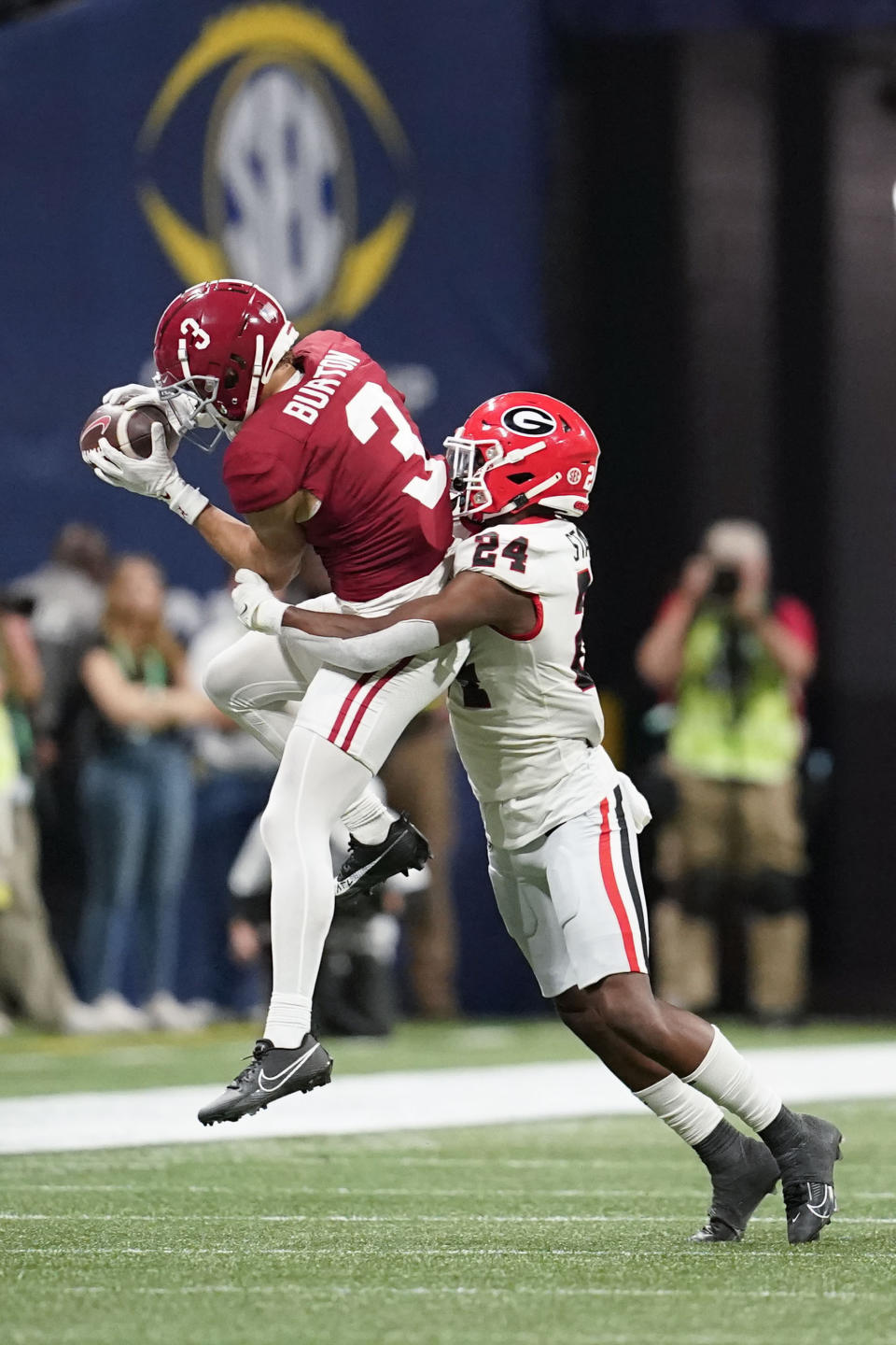 Alabama wide receiver Jermaine Burton (3) complete a pass against Georgia defensive back Malaki Starks (24) during the second half of the Southeastern Conference championship NCAA college football game in Atlanta, Saturday, Dec. 2, 2023. (AP Photo/Mike Stewart)