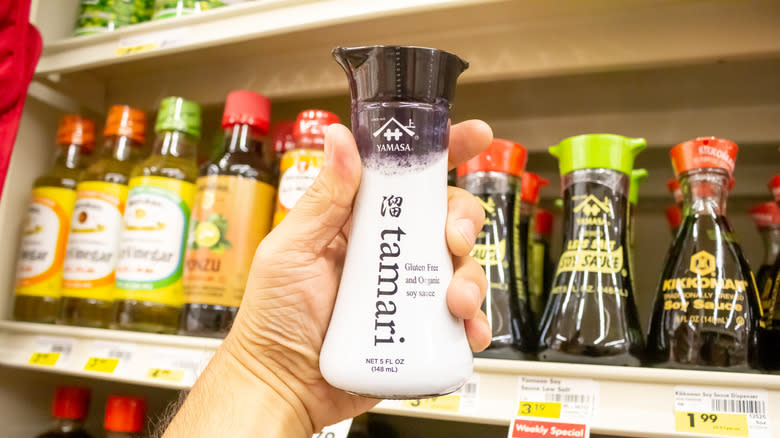 hand holding bottle of tamari