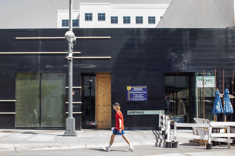 A man walks by a commercial business for rent at the Promenade in Santa Monica, California, on September 13, 2022. (Photo by Apu GOMES / AFP)