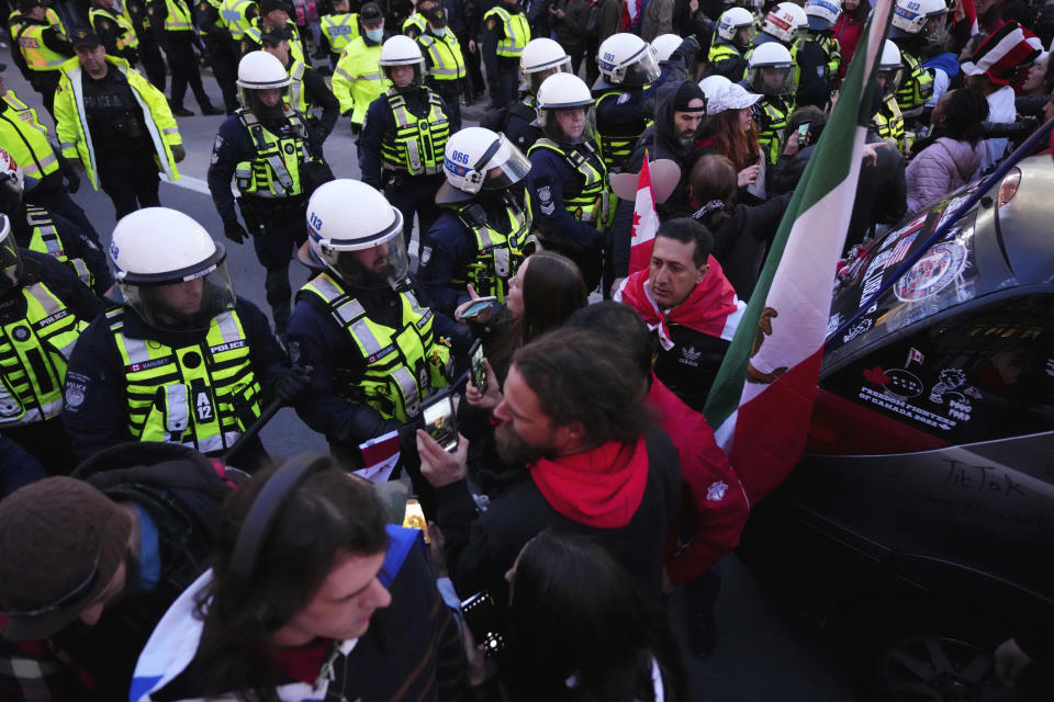 Protesters confront police during a demonstration, part of a convoy-style protest participants are calling "Rolling Thunder," in Ottawa, Ontario, Friday, April 29, 2022. (Sean Kilpatrick/The Canadian Press via AP)