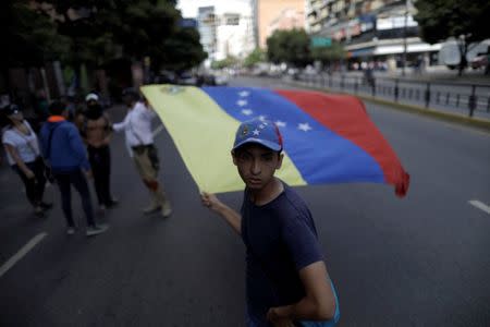 An opposition supporter looks on while rallying against Venezuela's President Nicolas Maduro's government in Caracas, Venezuela, August 4, 2017. REUTERS/Ueslei Marcelino