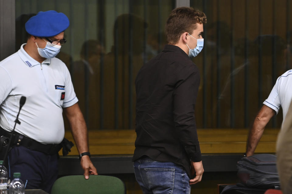 Gabriel Natale Hjorth, from the United States, center, leaves the courtroom where he stood trial for the killing of Italian Carabinieri police officer Mario Cerciello Rega, in Rome, Wednesday, July 22, 2020. Two tourists from California are accused of murdering Cerciello during their summer vacation in Italy in July 2019. (Andreas Solaro/Pool via AP)