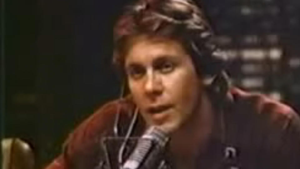 Gary Cole talking into a microphone and wearing headphones on Midnight Caller