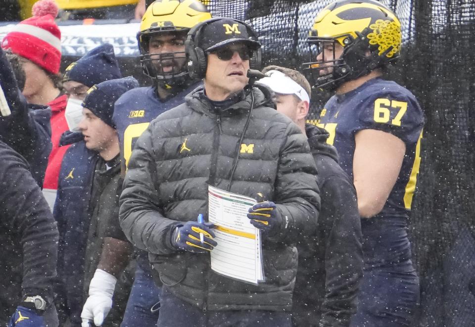 Michigan Wolverines head coach Jim Harbaugh stands on the sideline during the NCAA football game at Michigan Stadium in Ann Arbor on Monday, Nov. 29, 2021. 