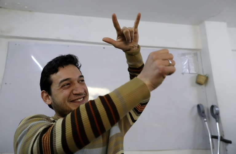 Ryad Hommos, a 21-year-old deaf Syrian, uses sign language during a class for deaf people at the EEMAA association, an NGO centre in Damascus' Midan district