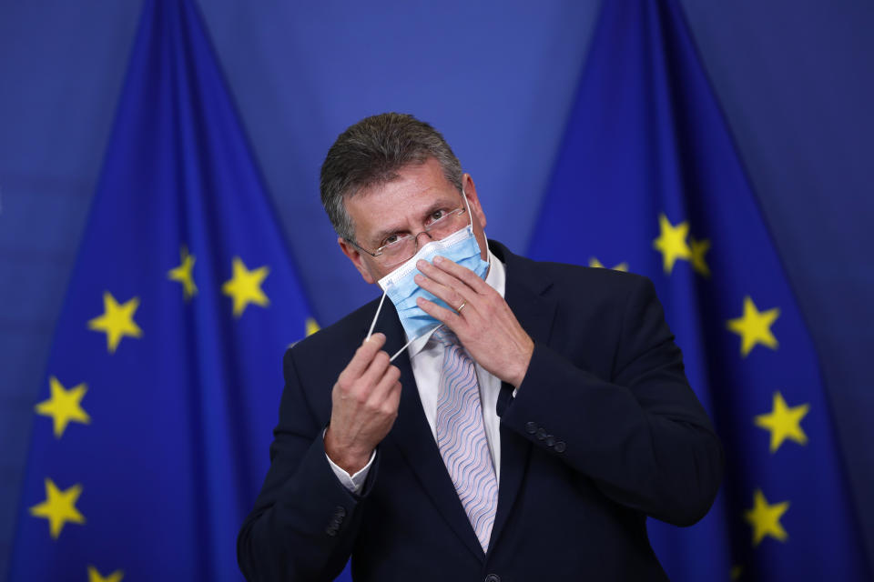 European Commissioner for Inter-institutional Relations and Foresight Maros Sefcovic removes his face mask as he gives a statement on European battery alliance at the European Commission headquarters in Brussels,Tuesday, Jan. 26. 2021. The European Union has approved €2.9 billion (US3.53 billion) in subsidies from 12 member countries for a second pan-European project to develop the bloc's electric battery industry and move away from its reliance on Asian imports. (AP Photo/Francisco Seco, Pool)