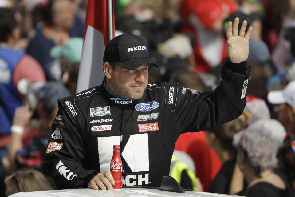 FILE - In this Feb. 16, 2020, file photo, Ryan Newman waves before the NASCAR Daytona 500 auto race at Daytona International Speedway in Daytona Beach, Fla. Newman says he will be ready to race when NASCAR resumes competition. He suffered a heady injury in the season-opening race at Daytona International Speedway. NASCAR says he still must be medically cleared. (AP Photo/Chris O'Meara, File)