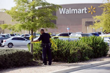 A police officer works on a crime scene after eight people believed to be illegal immigrants being smuggled into the United States were found dead inside a sweltering 18-wheeler trailer parked behind a Walmart store in San Antonio, Texas, U.S. July 23, 2017. REUTERS/Ray Whitehouse