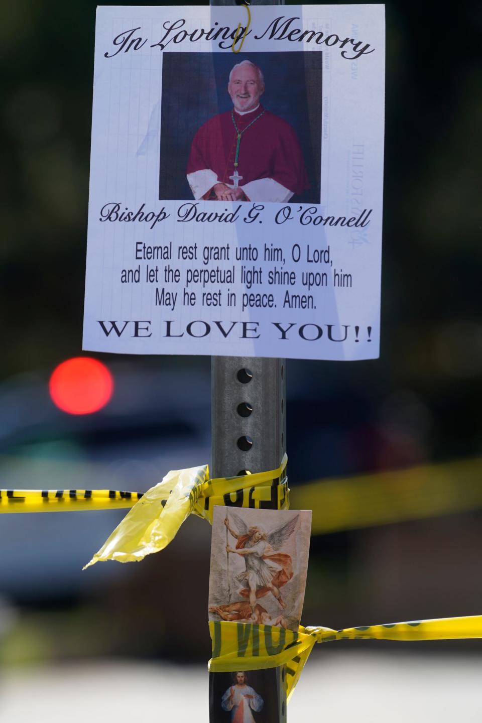 An image of Bishop David O'Connell is posted on the post of a street sign near his home in Hacienda Heights, Calif., Sunday, Feb. 19, 2023. O'Connell was shot and killed Saturday just blocks from a church, a slaying of a longtime priest hailed as a “peacemaker” that's stunned the Los Angeles religious community, authorities said.