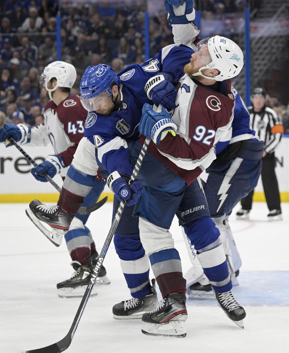 Tampa Bay Lightning defenseman Jan Rutta (44) checks Colorado Avalanche left wing Gabriel Landeskog (92) during overtime of Game 4 of the NHL hockey Stanley Cup Finals on Wednesday, June 22, 2022, in Tampa, Fla. (AP Photo/Phelan Ebenhack)