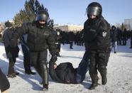 Police detain a man during a protest against the jailing of opposition leader Alexei Navalny in the Siberian city of Omsk, Russia, on Sunday, Jan. 31, 2021. Thousands of people took to the streets Sunday across Russia to demand the release of jailed opposition leader Alexei Navalny, keeping up the wave of nationwide protests that have rattled the Kremlin. Hundreds were detained by police. (AP Photo)