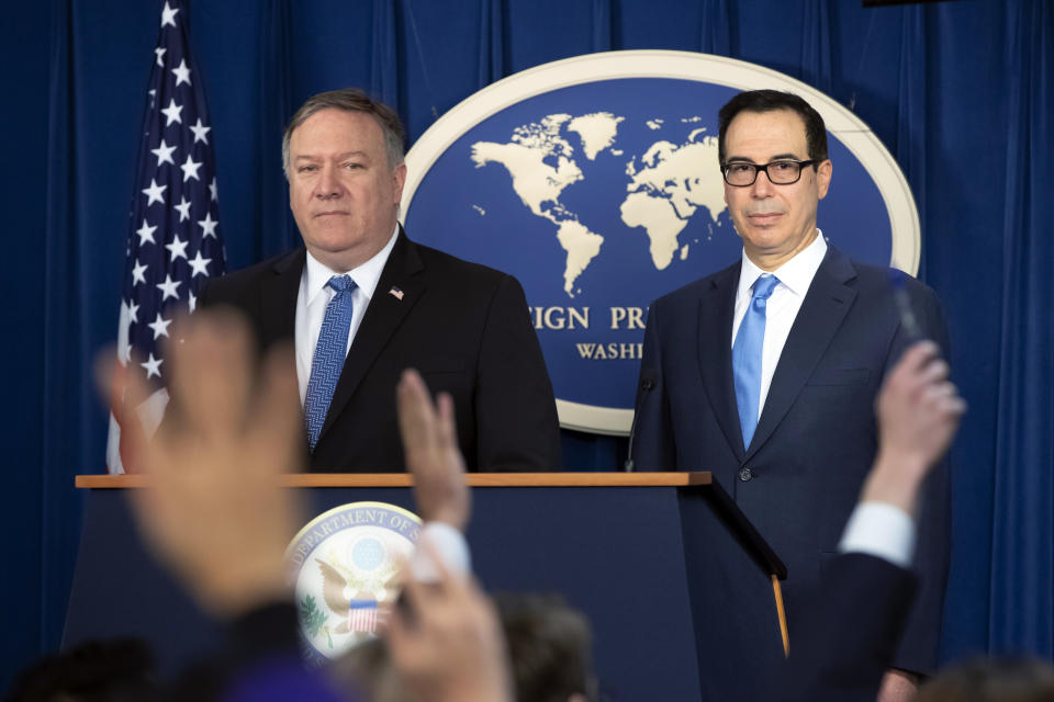 Secretary of State Mike Pompeo, left, and Treasury Secretary Steven Mnuchin, at the Foreign Press Center in Washington, Monday, Nov. 5, 2018. Mnuchin’s Treasury Department will be issuing around twice as much in U.S. government bonds in 2019 to finance the growing budget deficit as the department issued just two years ago. (AP Photo/J. Scott Applewhite)