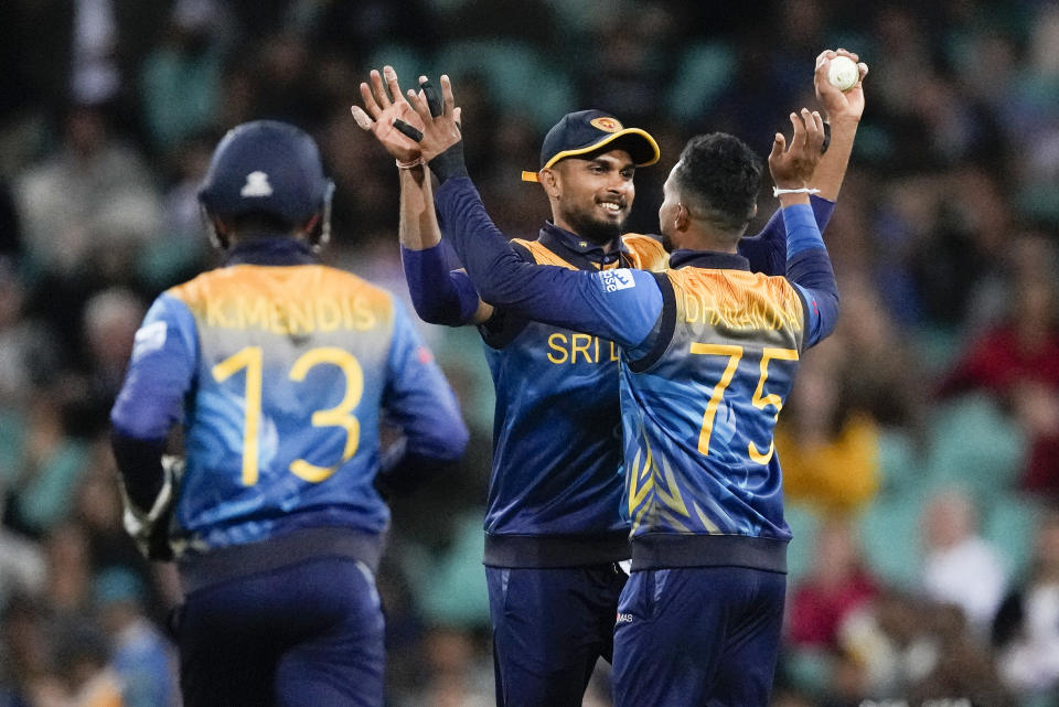 Sri Lanka's Dhananjaya de Silva, right, and teammate Dasun Shanaka celebrate the wicket of England's Moeen Ali during the T20 World Cup cricket match between England and Sri Lanka in Sydney, Australia, Saturday, Nov. 5, 2022. (AP Photo/Rick Rycroft)