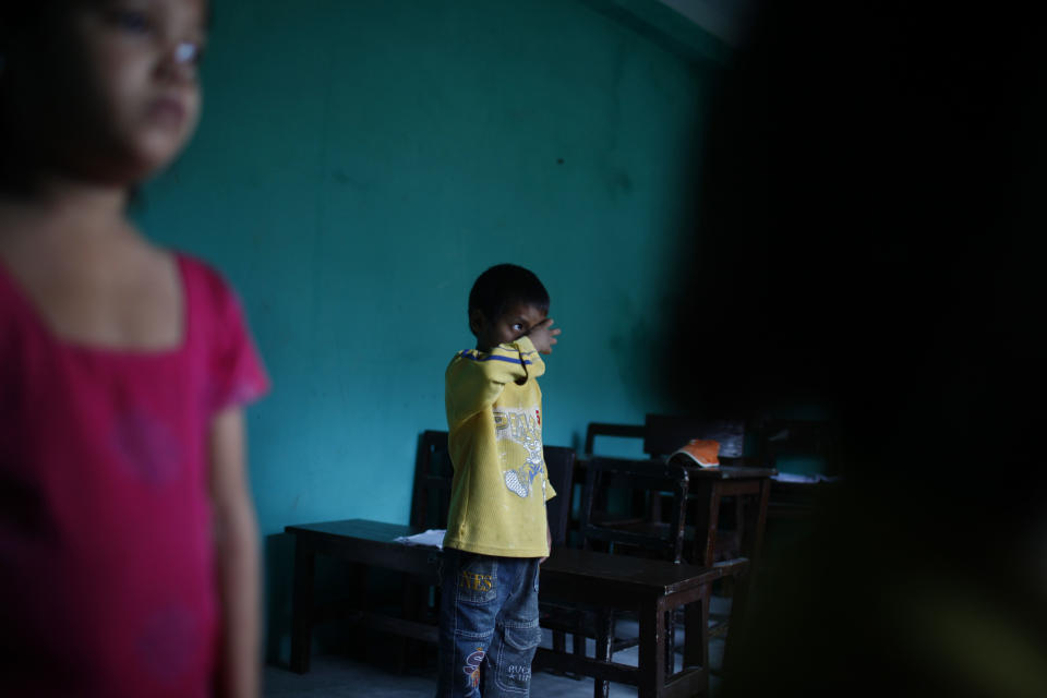 In this Tuesday, Aug. 21, 2012 photo, HIV patient Umesh Rana Magar does morning exercises at the Saphalta HIV Shiksya Sadan School, in Kirtipur, near Katmandu. Over the past three years, ten orphan children with HIV have come to the two-story house converted into a school by a high-school teacher named Raj Kumar Pun and a friend just outside the capital of this Himalayan nation. Soon, though, the makeshift home and school will close, since Pun, who has become weighed down by the relentless bills of keeping everything running was forced to sell the house. (AP Photo/Niranjan Shrestha)