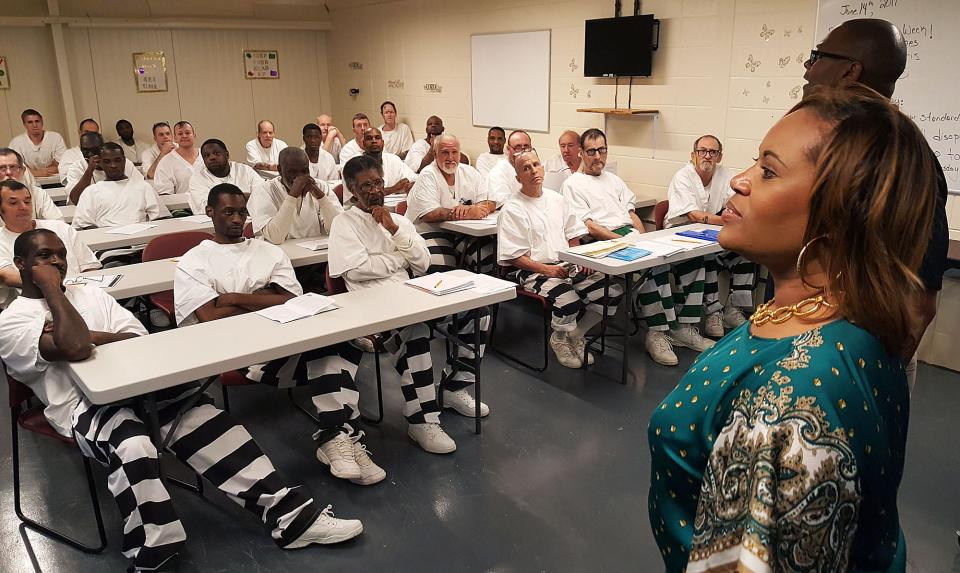 State Department of Corrections Deputy Commissioner of Institutions Jerry Williams, upper right, helps teach inmates at South Mississippi Correctional Institution in Leakesville about job interviewing strategies while Corrections Commissioner Pelicia Hall observes. The class is part of Hall’s plan big vision to turn the state’s prisons into places that teach and train offenders.