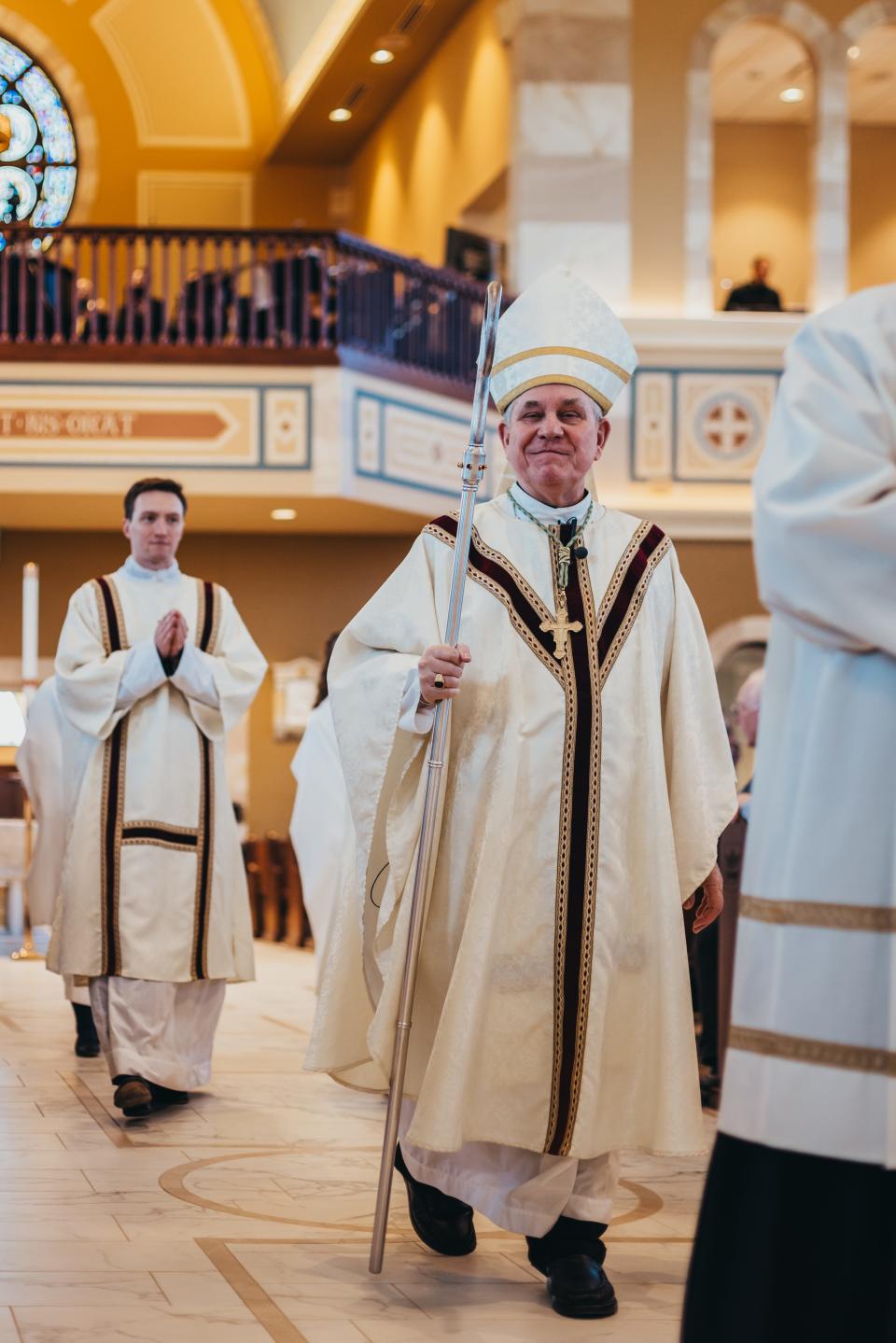Archbishop Jerome Listecki (front) and Deacon David Sweeney lead the dedication of the new church for St. Charles Catholic Parish in Hartland on April 6.