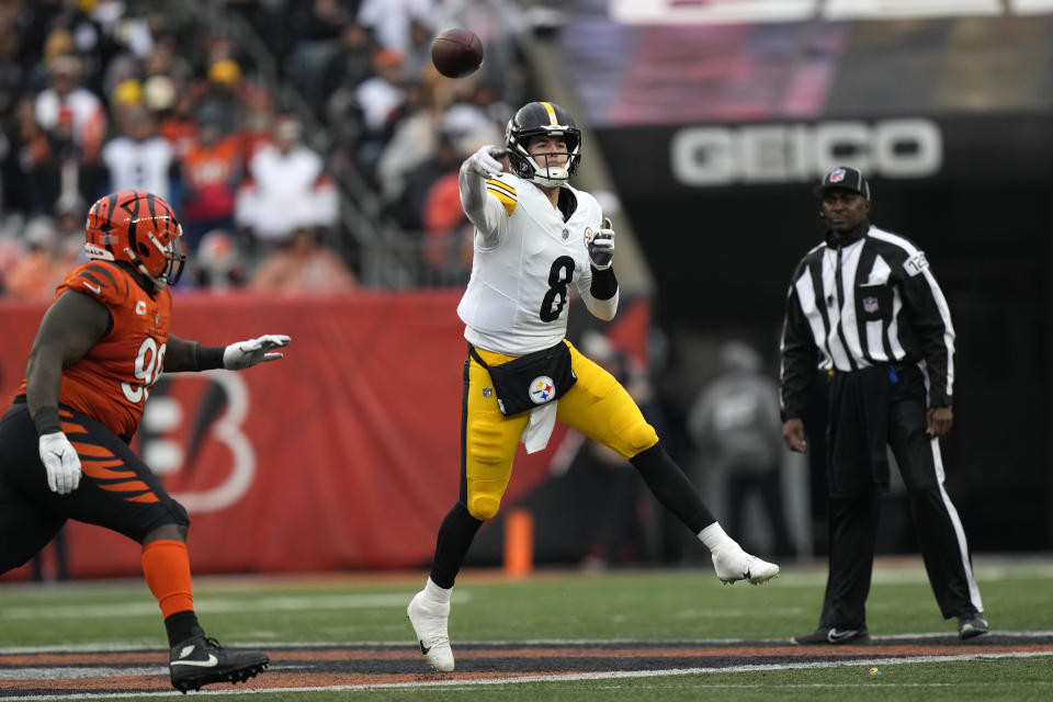 Pittsburgh Steelers quarterback Kenny Pickett (8) gets off a pass under pressure by Cincinnati Bengals defensive tackle DJ Reader, left, during the second half of an NFL football game in Cincinnati, Sunday, Nov. 26, 2023. (AP Photo/Carolyn Kaster)