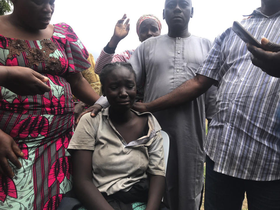 Parents are reunited with released students of the Bethel Baptist High School in Damishi, Nigeria, on Sunday, July 25, 2021. Armed kidnappers in Nigeria have released 28 of the more than 120 students who were abducted at the beginning of July from the Bethel Baptist High School in the northern town of Damishi. Church officials handed those children over to their parents at the school on Sunday. (AP Photo)