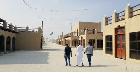 Residents walk at a new state-run development project in the old quarter of Shi'ite town Awamiya, Saudi Arabia January 8, 2019. REUTERS/Stephen Kalin