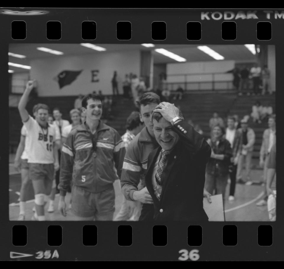 The Ball State University men's volleyball team celebrates with coach Don Shondell after their win at the Midwestern Intercollegiate Volleyball Association playoff game 1988 in Irving Gymnasium.