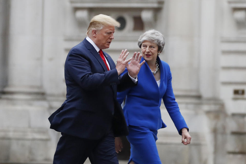 President Donald Trump walks with British Prime Minister Theresa May to a news conference at the Foreign Office, Tuesday, June 4, 2019, in central London. (AP Photo/Alex Brandon)