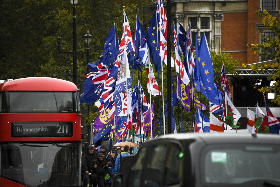 Various flags wave outside the houses of Parliament, in London, Monday, Oct. 21, 2019. There are just 10 days until the U.K. is due to leave the European bloc on Oct. 31. (AP Photo/Alberto Pezzali)