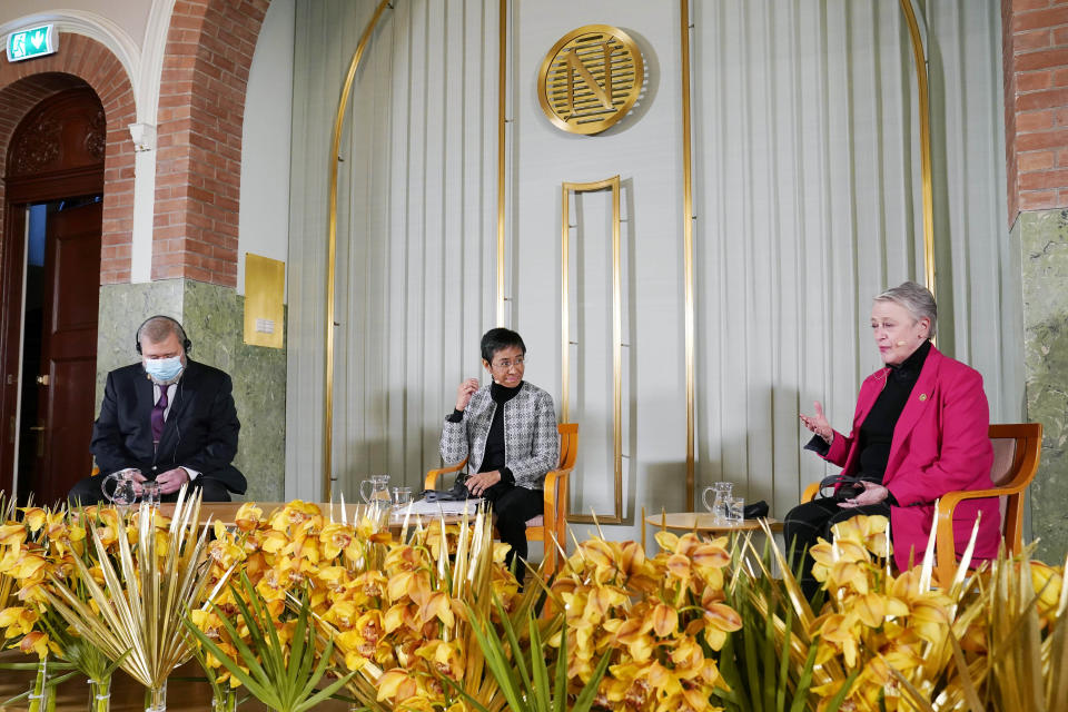 Peace Prize winners Russian journalist Dmitry Muratov, left and Philippines' journalist Maria Ressa, centre, sit with the chair of the Nobel Committee Berit Reiss-Andersen, right, during a press conference, at the Nobel Institute, a day prior to the award ceremony, in Oslo, Norway, Thursday, Dec. 9, 2021. (Torstein Boe/Pool Photo via AP)
