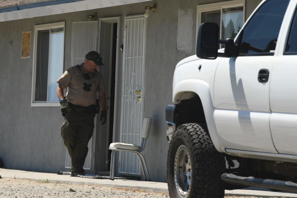 A Mineral County sheriff's deputy exits an apartment in Walker Lake, Nevada, associated with Santino William Legan, 19.