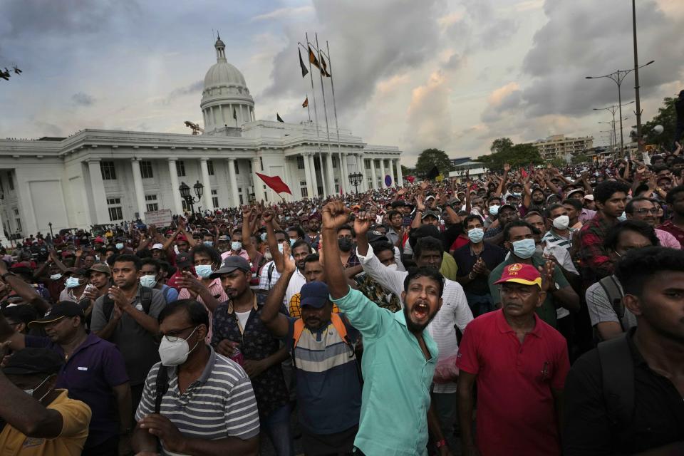 FILE- Sri Lanka's opposition party members shout anti-government slogans during a protest rally against the economic crisis in Colombo, Sri Lanka, Tuesday, April 19, 2022. China says its initiative to build ports and other infrastructure paid for with Chinese loans across Asia and Africa will boost trade. But in a cautionary tale for other borrowers, Sri Lanka's debt to Beijing threatens to hold back efforts to resolve a financial crisis so severe that this Indian Ocean nation cannot import food or gasoline. (AP Photo/Eranga Jayawardena, File)