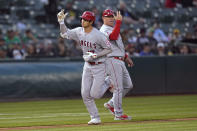 Los Angeles Angels' Shohei Ohtani, left, celebrates with third base coach Phil Nevin after hitting a two-run home run during the fifth inning of the second baseball game of the team's doubleheader against the Oakland Athletics in Oakland, Calif., Saturday, May 14, 2022. It is Ohtani's 100th homer in the majors. (AP Photo/Jeff Chiu)