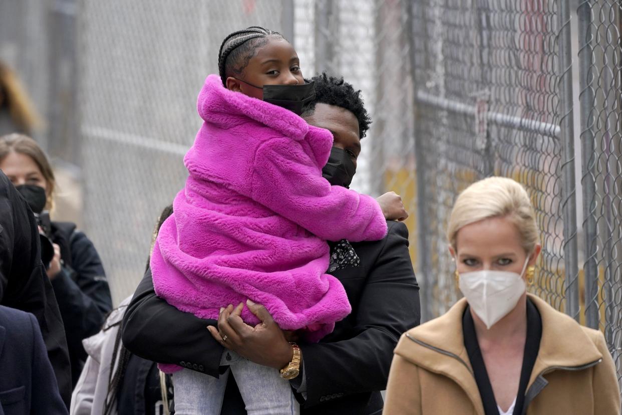 Gianna Floyd, the daughter of George Floyd, is carried as she walks with family members outside the Hennepin County Government Center in Minneapolis on Monday, April 19, before the murder trial against former Minneapolis police officer Derek Chauvin advanced to jury deliberations. 