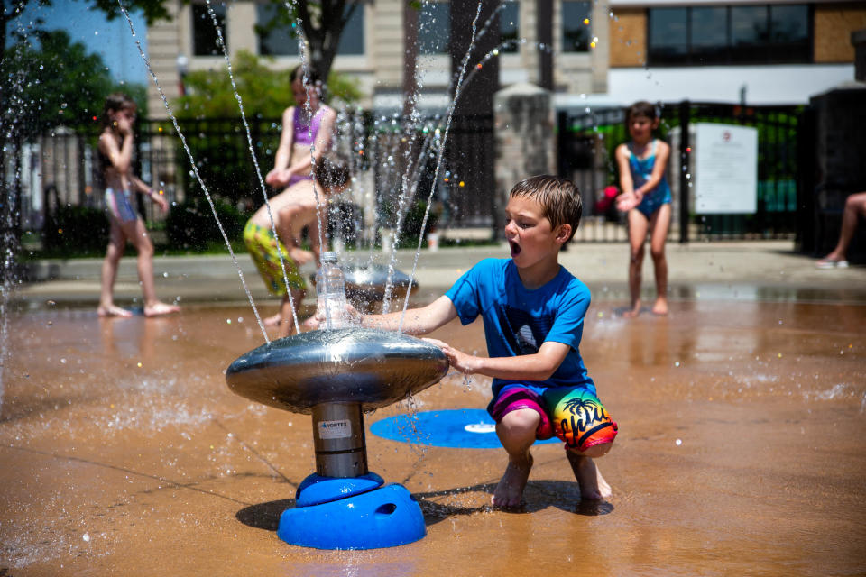 Children beat the heat as they play in the water of the Zeeland Splash Pad on Tuesday, June 14.