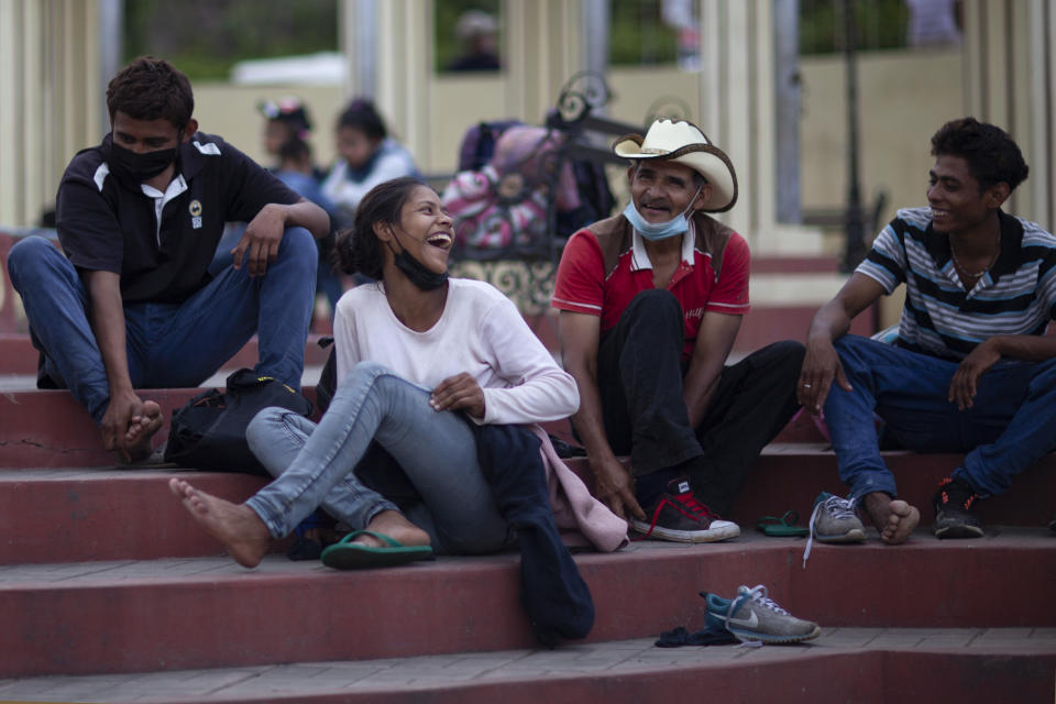 Migrants hoping to reach the distant U.S. border rest on the side of a highway, in Jocotan, Guatemala, Saturday, Jan. 16, 2021. Honduran migrants pushed their way into Guatemala Friday night without registering, a portion of a larger migrant caravan that had left the Honduran city of San Pedro Sula before dawn, Guatemalan authorities said. (AP Photo/Sandra Sebastian)