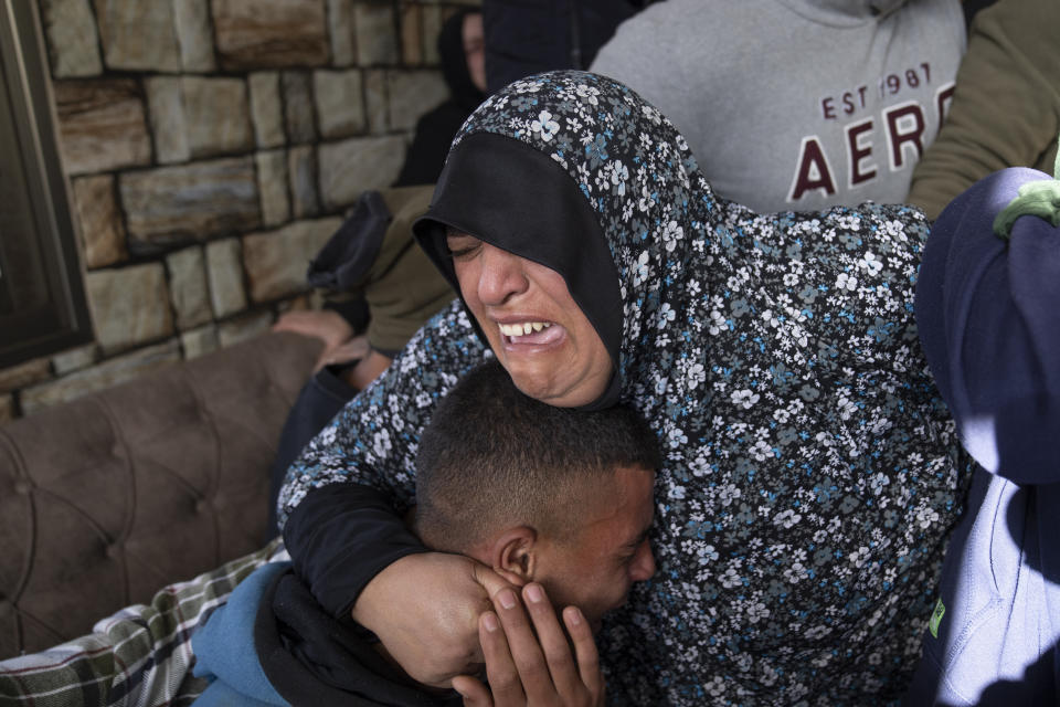 Mourners cry after taking the last look at the body of Palestinian Abdel Rahman Hamed, 18 during his funeral in the West Bank town of Silwad Monday, Jan. 29, 2024. Palestinian authorities say five Palestinians have been killed by Israeli forces in separate shootings across the occupied West Bank on Monday including Hamed who was killed during clashes with Israeli border police at his home village of Silwad. (AP Photo/Nasser Nasser)
