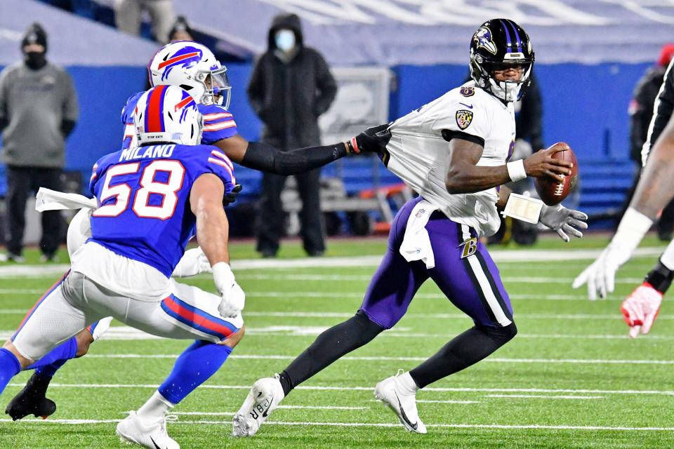 Buffalo Bills cornerback Levi Wallace grabs the jersey of Baltimore Ravens quarterback Lamar Jackson during the first half at Bills Stadium.