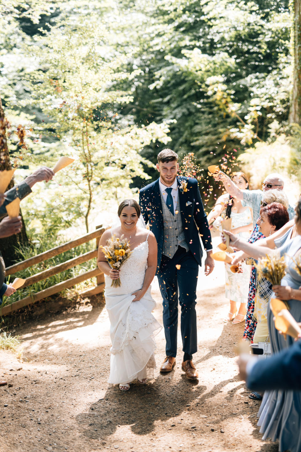 Wedding guests showered Lauren and Adam in home-made rose petal confetti (Image: @agapestories_)