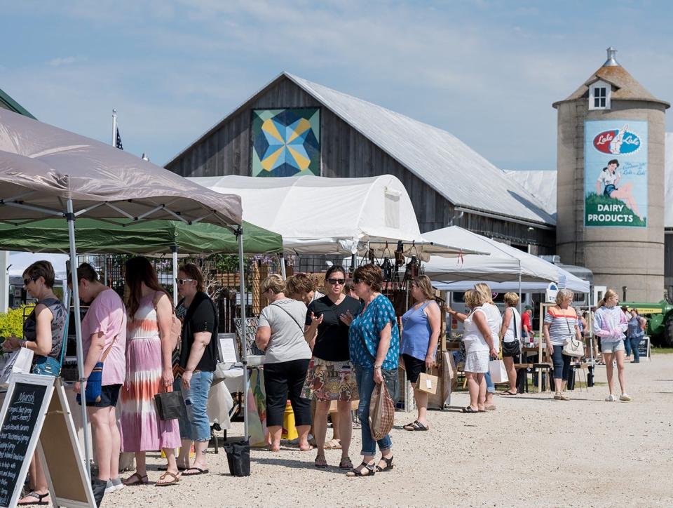 Visitors check out the goods at The Rusty Coop, a two-day upscale vintage-style barn market unique to Wisconsin and held in June 2021 at Kewaunee Heritage Farm. The Rusty Coop returns for its second edition June 2 and 3 at Door County Cherry Hut in Fish Creek.