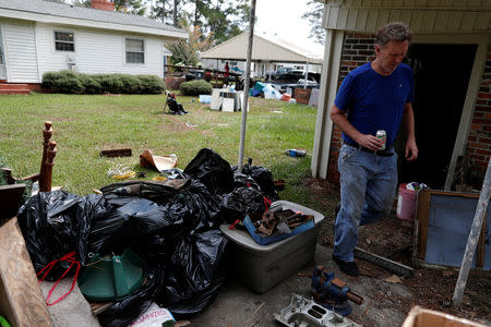 Jim Dotson works to clean his yard after flooding due to Hurricane Florence receded in Fair Bluff, North Carolina, U.S. September 29, 2018. REUTERS/Randall Hill