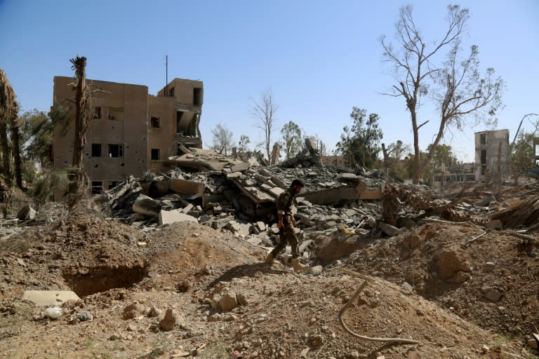 A member of the Syrian Democratic Forces (SDF) walks amidst the rubble on June 27, 2017 in the suburb of Dariya on the western city limits of Raqa after the area was seized from the Islamic State (IS) group