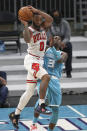 Chicago Bulls guard Coby White, left, collides with Charlotte Hornets guard Terry Rozier (3) during the second half of an NBA basketball game in Charlotte, N.C., Thursday, May 6, 2021. (AP Photo/Nell Redmond)