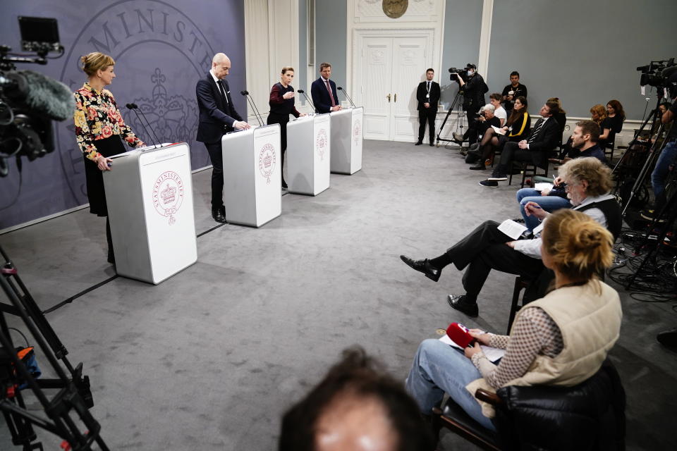 Denmark's Prime Minister Mette Frederiksen, centre right, takes part in a coronavirus press conference with Minister of Health Magnus Heunicke, centre, director of the Statens Serum Institut Tyra Grove Krause, left, and director of the National Board of Health Soeren Brostroem, centre at right, in Copenhagen, Denmark, Wednesday Jan. 26, 2022. (Mads Claus Rasmussen/Ritzau Scanpix via AP)