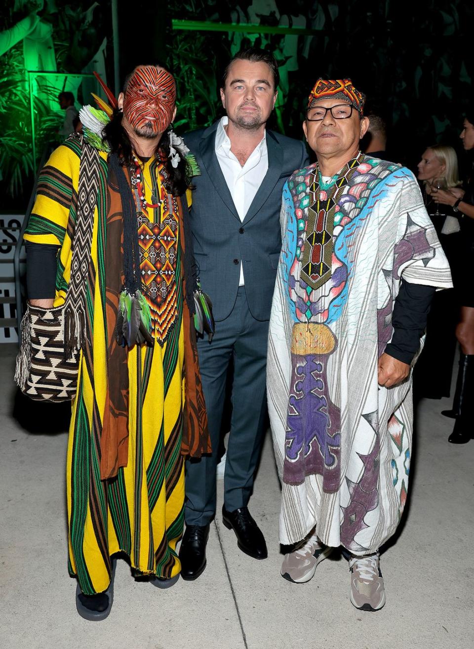 miami, florida december 07 l r nixiwaka yawanaw, leonardo dicaprio, and isku kua yawanaw attend rewild 'art of nature' basel event on december 07, 2023 in miami, florida photo by dimitrios kambourisgetty images for rewild