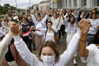 About 200 women march in solidarity with protesters injured in the latest rallies against the results of the country's presidential election in Minsk, Belarus, Wednesday, Aug. 12, 2020. Belarus officials say police detained over 1,000 people during the latest protests against the results of the country's presidential election. (AP Photo)