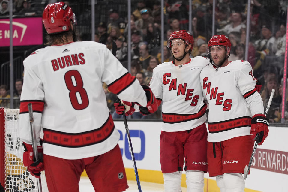 Carolina Hurricanes right wing Stefan Noesen, right, celebrates after scoring against the Vegas Golden Knights during the third period of an NHL hockey game Saturday, Feb. 17, 2024, in Las Vegas. (AP Photo/John Locher)