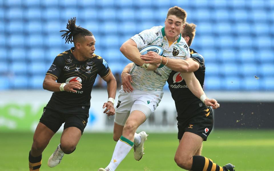 Tommy Freeman of Northampton Saints looks to break past Josh Bassett of Wasps during the Gallagher Premiership Rugby match between Wasps and Northampton Saints at The Coventry Building Society Arena on October 10, 2021 in Coventry - GETTY IMAGES